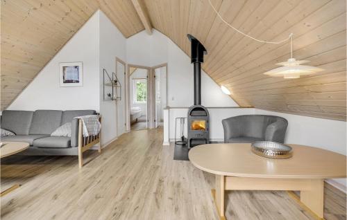a living room with a wood stove in a house at Gorgeous Home In Gråsten With Sauna in Gråsten