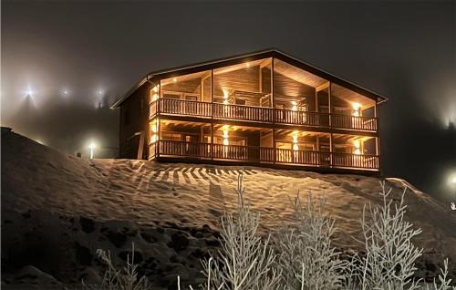 a wooden house on top of a hill at night at Gorgeous Home In Sysslebäck With Sauna in Sysslebäck