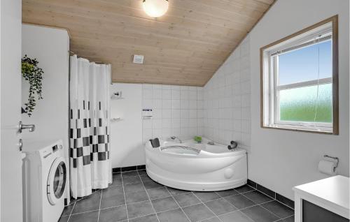 a white bathroom with a tub and a window at Stunning Home In Lemvig With Wifi in Lemvig