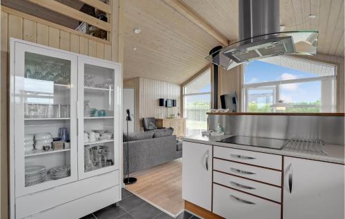 a kitchen with white cabinets and a couch at Stunning Home In Lemvig With Wifi in Lemvig