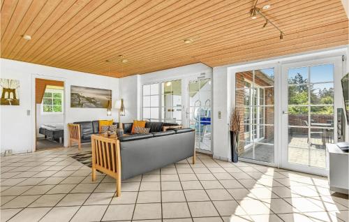 a living room with a couch and a table at Lovely Home In Ringkøbing With Sauna in Ringkøbing
