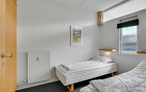 a bedroom with two beds and a window at Awesome Apartment In Faaborg With Kitchen in Fåborg