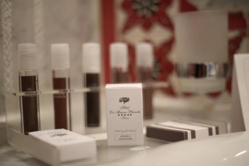 a counter top with a bunch of lipstick products at Hôtel La Maison Blanche in Tunis