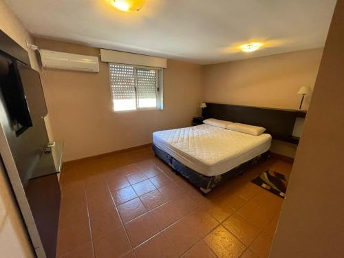 a small bedroom with a bed and a window at Temporarios Lili in San Salvador de Jujuy