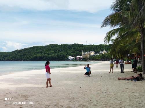 a group of people standing on a beach at Bebe Homestay Phu Quoc in Phu Quoc