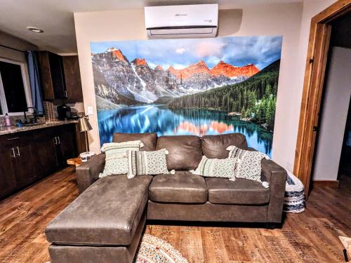 a living room with a couch in front of a mountain mural at The Luminous Lodge-Remodeled Cabin W/ Valley Views in Santa Ysabel