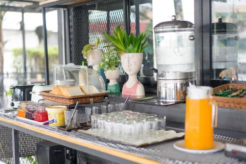 a counter with some food and drinks on it at It's me Keawanong Hotel in Nakhon Ratchasima