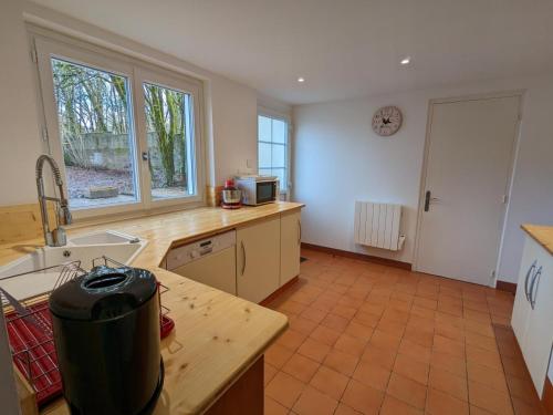 a kitchen with a sink and a counter top at Gîte Familial Rénové en Pleine Nature avec Jardin, Terrasse et Activités de Plein Air - FR-1-653-227 in Puyréaux