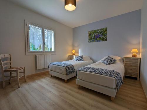 1 dormitorio con 2 camas, silla y ventana en Gîte Puyréaux, 4 pièces, 5 personnes - FR-1-653-227, en Puyréaux