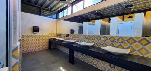 a public bathroom with a row of sinks at ChangoMango in La Ventana