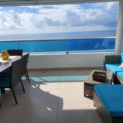 a dining room with a view of the ocean on a ship at Beachfront, Juandolio in Juan Dolio