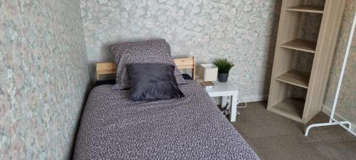 a small bedroom with a bed and a desk at SUPERB FLAT WITH 3 BEDROOMS PARKING AND BALCONy in Antwerp