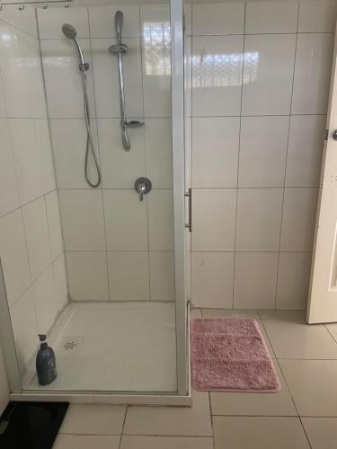 a shower with a glass door in a bathroom at Private Room Near Melbourne Airport in Deer Park