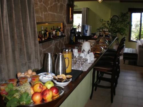 a kitchen with a breakfast bar with fruits and vegetables at Olympia Guesthouse in Vergina