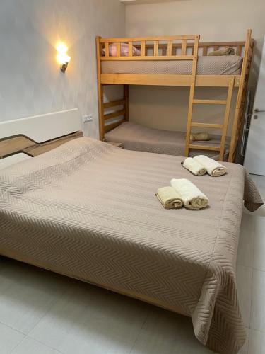 a bedroom with two bunk beds and two towels at Hillside Bakuriani in Bakuriani