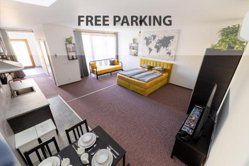 a living room with a free parking sign on the wall at APARTMANY Plzeňská 465 Free PARKING & PS3 in Prague