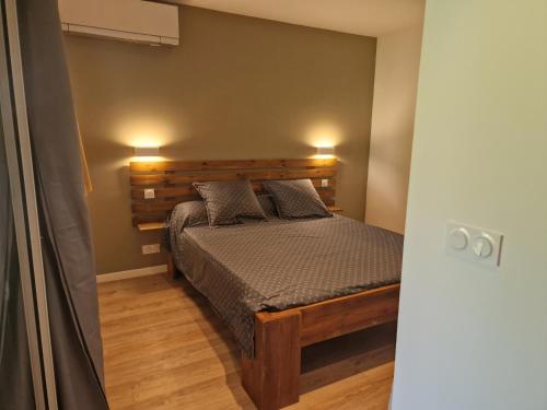 a bedroom with a bed with two pillows on it at Appartement les petits Baobabs in Mamoudzou