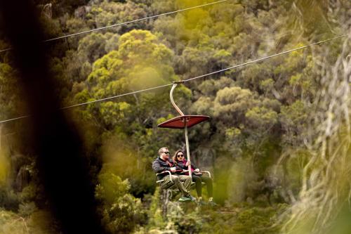 a man and woman sitting on a zip line at BIG4 Launceston Holiday Park in Launceston