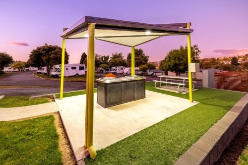 a barbecue grill with a canopy in a park at BIG4 Launceston Holiday Park in Launceston