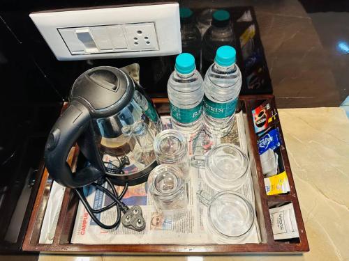 a tray with bottles of water and a blender at Hotel Majestic in Kolkata