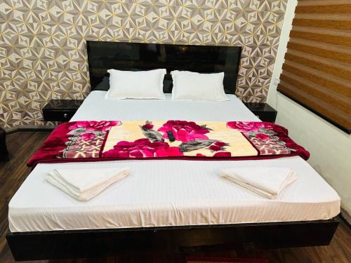 a bed in a room with two plates on it at Hotel Majestic in Kolkata