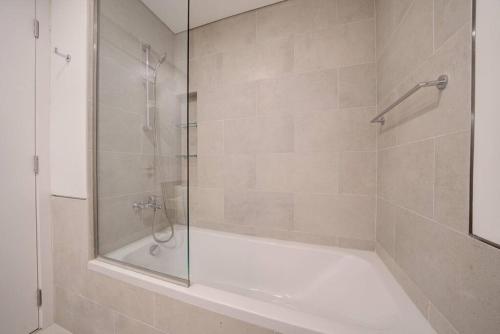 a bathroom with a shower with a glass door at Fantastic View l 2BR l Fully Equipped in Dubai