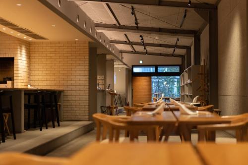 a dining room with wooden tables and chairs at arita huis in Arita