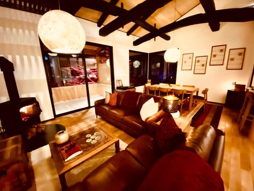 a living room with a couch and a table at Snowman Apartments at Madarao Mountain in Iiyama