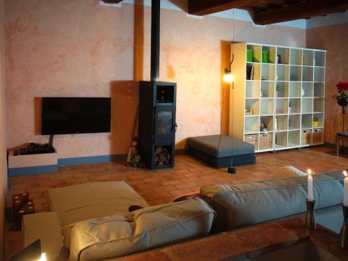 a living room with couches and a flat screen tv at Polvereto in Le Fornacette