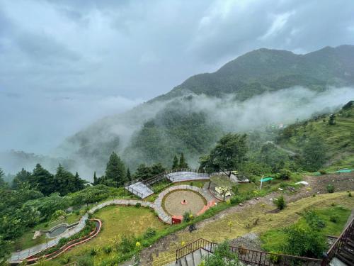 a farm on a hill in the mountains at Atulyam, Pangot in Nainital