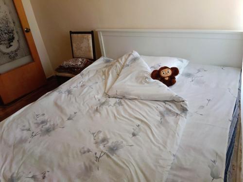 a teddy bear laying on top of a bed at Guest House Armina in Yerevan