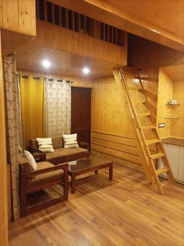 a living room with a couch and a staircase at Atulyam, Pangot in Nainital