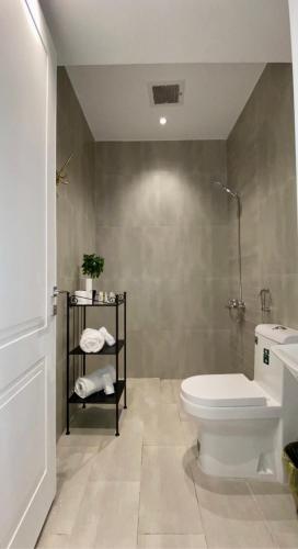 a bathroom with a white toilet and a shower at Spacious new 2 bedroom Apt-in amazing location B9 in Riyadh