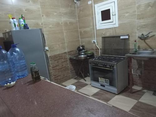 a small kitchen with a stove and a sink at IKEA Flats in Hurghada