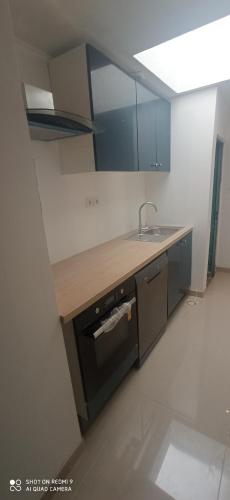 a kitchen with a sink and a counter top at Chambres privatives avec espaces partagés dans maison Roubaix centre in Roubaix