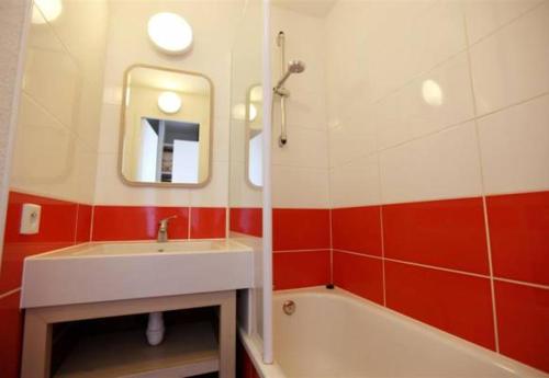 a bathroom with a sink and a tub and a mirror at F2 résidence Antarès in Avoriaz