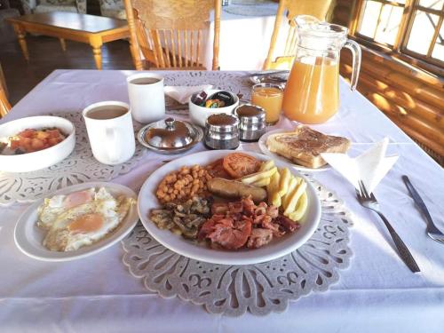 a table with a plate of breakfast food on it at Ledges Retreat in Bergville