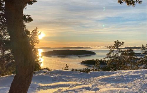 a winter sunset over a body of water at Beautiful Home In Domsjö With Sauna in Domsjö