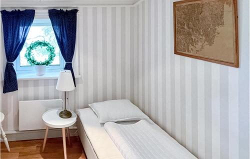 a small room with a bed and a window at Cozy Home In Domsj With Kitchen in Domsjö
