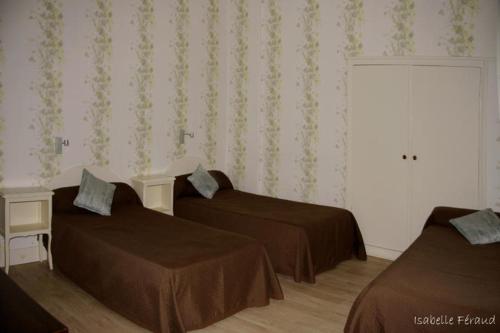 a hotel room with two beds and a window at Hotel Saint Jean in Chalon-sur-Saône