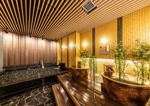 a bathroom with two sinks and a bath tub at APA Hotel & Resort Osaka Umeda Eki Tower in Osaka