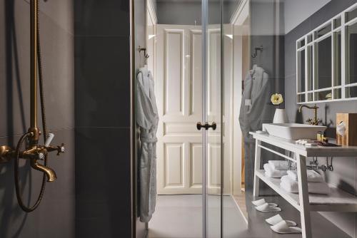 a bathroom with a shower and a sink at Bohemian Suites Athens in Athens