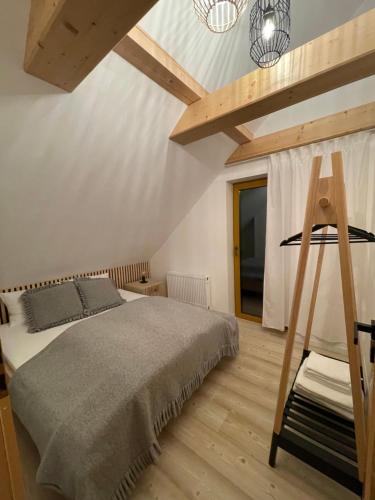 a bedroom with a large bed and a wooden ladder at Świerkowa Osada in Istebna