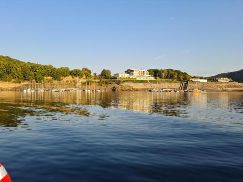 a large body of water with houses in the background at Ferienwohnung Katharina 4 Sterne laut DTV Wallbox 11KW in Nideggen
