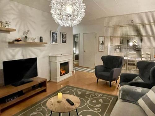 a living room with a television and a fireplace at City apartment in Rovaniemi