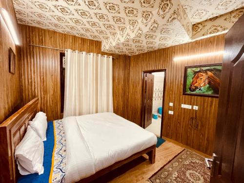 a bedroom with a bed and a painting of a horse on the ceiling at Casa Arhan 2-3-4-7-12 BHK Luxury Penthouse in Mussoorie