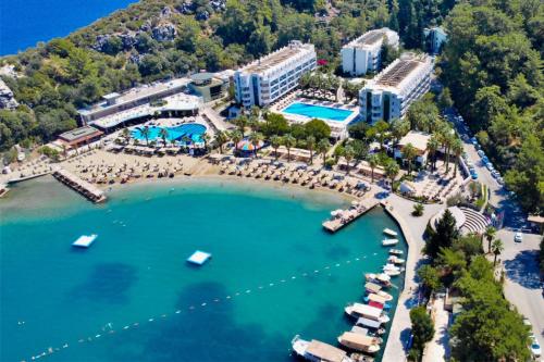 an aerial view of a resort with boats in the water at Turunc Resort Hotel in Turunç
