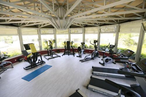 a gym with several treadmills and elliptical machines at Turunc Resort Hotel in Turunc