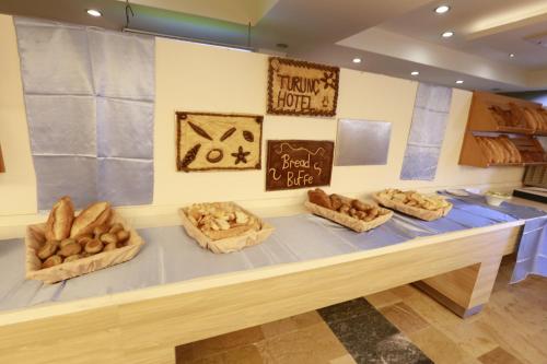a table with four baskets of bread on it at Turunc Resort Hotel in Turunc