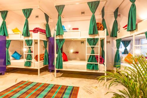 a room with bunk beds with curtains and a rug at goSTOPS Lite Jaipur in Jaipur